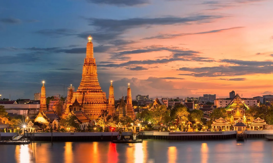 Templo Wat Arun iluminado sobre el río en Bangkok, Tailandia